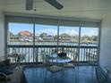 Enclosed patio with seating featuring views of the canal and nearby docks at 326 Windrush Blvd # 103, Indian Rocks Beach, FL 33785