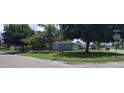 Charming single-story home featuring a well-maintained lawn and mature trees at 4105 W Tyson Ave, Tampa, FL 33611