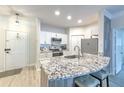 This kitchen features granite counters, white cabinets and bar stool seating at 4207 S Dale Mabry Hwy # 2101, Tampa, FL 33611