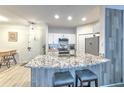 This kitchen features granite counters, white cabinets and bar stool seating at 4207 S Dale Mabry Hwy # 2101, Tampa, FL 33611