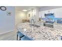 Bright kitchen featuring granite countertops, stainless appliances, and white cabinetry at 4207 S Dale Mabry Hwy # 2101, Tampa, FL 33611