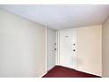 Hallway view showing two doors with fresh paint and clean carpet; a blank canvas ready to be customized at 440 S Gulfview Blvd # 701, Clearwater Beach, FL 33767