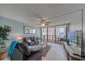 Comfortable living room with modern decor, ceiling fan, and sliding glass doors leading to a scenic balcony at 440 S Gulfview Blvd # 701, Clearwater Beach, FL 33767