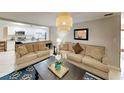 Inviting living room featuring neutral color scheme, plush sofas, and an open kitchen view at 4505 S Clark Ave, Tampa, FL 33611