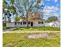 Charming single-story home with a well-maintained lawn and a freshly painted exterior at 4718 W Oklahoma Ave, Tampa, FL 33616
