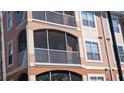 Close up of the three-story condo building with screened patios at 5000 Culbreath Key Way # 1-220, Tampa, FL 33611
