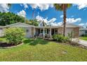 Charming single-story home featuring a well-manicured lawn, stone accents, and a welcoming front entrance at 5936 13Th Ave, New Port Richey, FL 34652