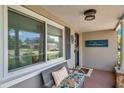 Inviting front porch with seating, decorative touches, and a 'Hello and Welcome' sign, offering a warm greeting at 5936 13Th Ave, New Port Richey, FL 34652