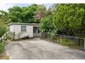 This property features a spacious driveway surrounded by mature trees and landscaping at 6006 Axelrod Rd, Tampa, FL 33634