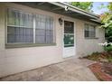 Charming single-story home featuring a bright front entrance with secure screen door and lovely curb appeal at 6006 Axelrod Rd, Tampa, FL 33634