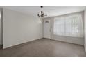 Inviting living room with sheer curtains and chandelier at 6006 Axelrod Rd, Tampa, FL 33634