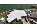 Waterfront home showcasing lush landscaping, a private pool, and stunning canal views at 649 Normandy Rd, Madeira Beach, FL 33708