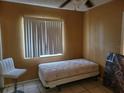 Small bedroom with tan walls, tiled floor, a twin bed, and a bright window at 6818 59Th St, N., Pinellas Park, FL 33781