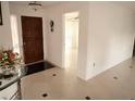Inviting foyer with ceramic tile flooring, chandelier, and access to other rooms at 7031 Drury St, Tampa, FL 33635