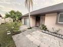 Attractive front entrance with stone pavers, mature landscaping, and a covered entryway at 7031 Drury St, Tampa, FL 33635