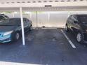Designated carport parking with limited space between vehicles and privacy fencing at 802 Brandy Wine Dr # 802, Largo, FL 33771