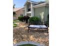The front yard is decorated with a bench and unique shrubbery at 8101 Roxboro Dr, Hudson, FL 34667