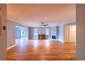 Spacious living room featuring a fan, fireplace, and hardwood floors at 10196 Seminole Island Dr, Largo, FL 33773