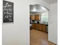 Traditional kitchen with wooden cabinets and modern stainless steel appliances seen through an arched doorway at 1116 W Kirby St, Tampa, FL 33604