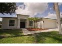Charming single-story home featuring a well-maintained lawn and inviting curb appeal with decorative landscaping at 11403 Wellman Dr, Riverview, FL 33578