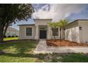 Inviting single-story home with fresh exterior paint, a well-kept lawn, and decorative landscaping at 11403 Wellman Dr, Riverview, FL 33578