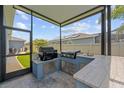 Inviting outdoor kitchen featuring a built-in grill, marble countertops, and a convenient sink at 11714 Tetrafin Dr, Riverview, FL 33579