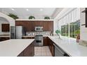 Spacious kitchen with stainless steel appliances, tile backsplash, and a bright window overlooking the yard at 12439 Bristol Commons Cir, Tampa, FL 33626