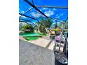 Enjoy outdoor living in this screened pool area with a lounge area and views of the surrounding landscape at 12603 Midpointe, Riverview, FL 33578