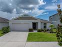 Charming single-Gathering home with a well-maintained lawn and a two-car garage at 13105 Fruitville Way, Riverview, FL 33579