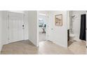 Bright entryway with tile floors leading to a bathroom and a room with a desk at 15825 Mauvewood Ave, Odessa, FL 33556