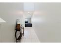 Bright hallway with tile flooring and neutral walls, leading to the living areas of the home at 17156 Yellow Pine St, Wimauma, FL 33598