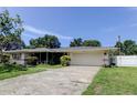 Single-story home featuring a well-maintained lawn and an attached two-car garage at 1868 Lombardy Dr, Clearwater, FL 33755