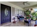 Inviting front porch with tiled floors, ceiling fan, and comfortable seating at 1868 Lombardy Dr, Clearwater, FL 33755