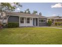Attractive single-story home featuring a well-kept lawn and a welcoming front entrance at 1882 Maryland Ne Ave, St Petersburg, FL 33703