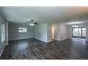 Spacious living room with wood floors, ceiling fan, and sliding glass doors to the backyard at 1882 Maryland Ne Ave, St Petersburg, FL 33703