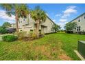 Townhome featuring verdant lawn and landscaping, offering ample outdoor enjoyment at 19272 Blue Pond Dr, Lutz, FL 33558