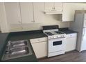 Functional kitchen featuring white cabinets, laminate counters, and modern appliances at 205 Summer Sails Dr, Valrico, FL 33594