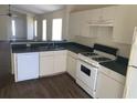 Bright eat-in kitchen with white cabinets, modern appliances, and seamless connection to the living area at 205 Summer Sails Dr, Valrico, FL 33594