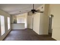 Open-concept living area with neutral tones, ceiling fan, and abundant natural light at 205 Summer Sails Dr, Valrico, FL 33594