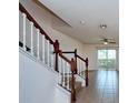 Open concept living room featuring tile flooring, a ceiling fan, and sliding doors to the outside at 2066 Sun Down Dr, Clearwater, FL 33763