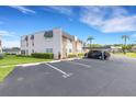 Exterior of condo building with dedicated parking spaces for residents, landscaped lawns, and parking at 221 Fernwood Cir # 221, Seminole, FL 33777