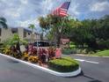 Welcoming entrance to Fernwood Circle, a 55+ community with well-maintained landscaping and palm trees at 221 Fernwood Cir # 221, Seminole, FL 33777