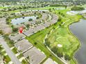 Expansive aerial view showcasing a golf course community with several lakes, lush greenery, and well-spaced homes at 2292 Sifield Greens Way # 59, Sun City Center, FL 33573