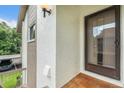 Condo entrance with a brown security door and red tile floor at 2368 Flanders Way # D, Safety Harbor, FL 34695
