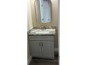 Compact bathroom featuring a vanity with a marble countertop and gold hardware accents at 2404 Cassell St, Tampa, FL 33605
