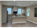 Bright kitchen with island, stainless appliances, and white cabinets offering modern appeal at 2404 Cassell St, Tampa, FL 33605