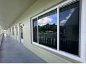 Exterior view with large sliding glass windows and muted green siding, showcasing the building's design at 2459 Columbia Dr # 39, Clearwater, FL 33763