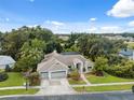 Expansive home with manicured lawn, mature trees, three-car garage and screened in pool at 3037 Crest Dr, Clearwater, FL 33759