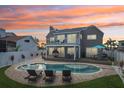 Inviting backyard with a private pool, spacious patio, comfortable lounge chairs, and outdoor dining area at 311 22Nd St, Belleair Beach, FL 33786