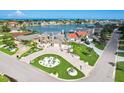 Aerial view of an upscale neighborhood, highlighting a stunning two-story home with manicured lawns and lush landscaping at 311 22Nd St, Belleair Beach, FL 33786